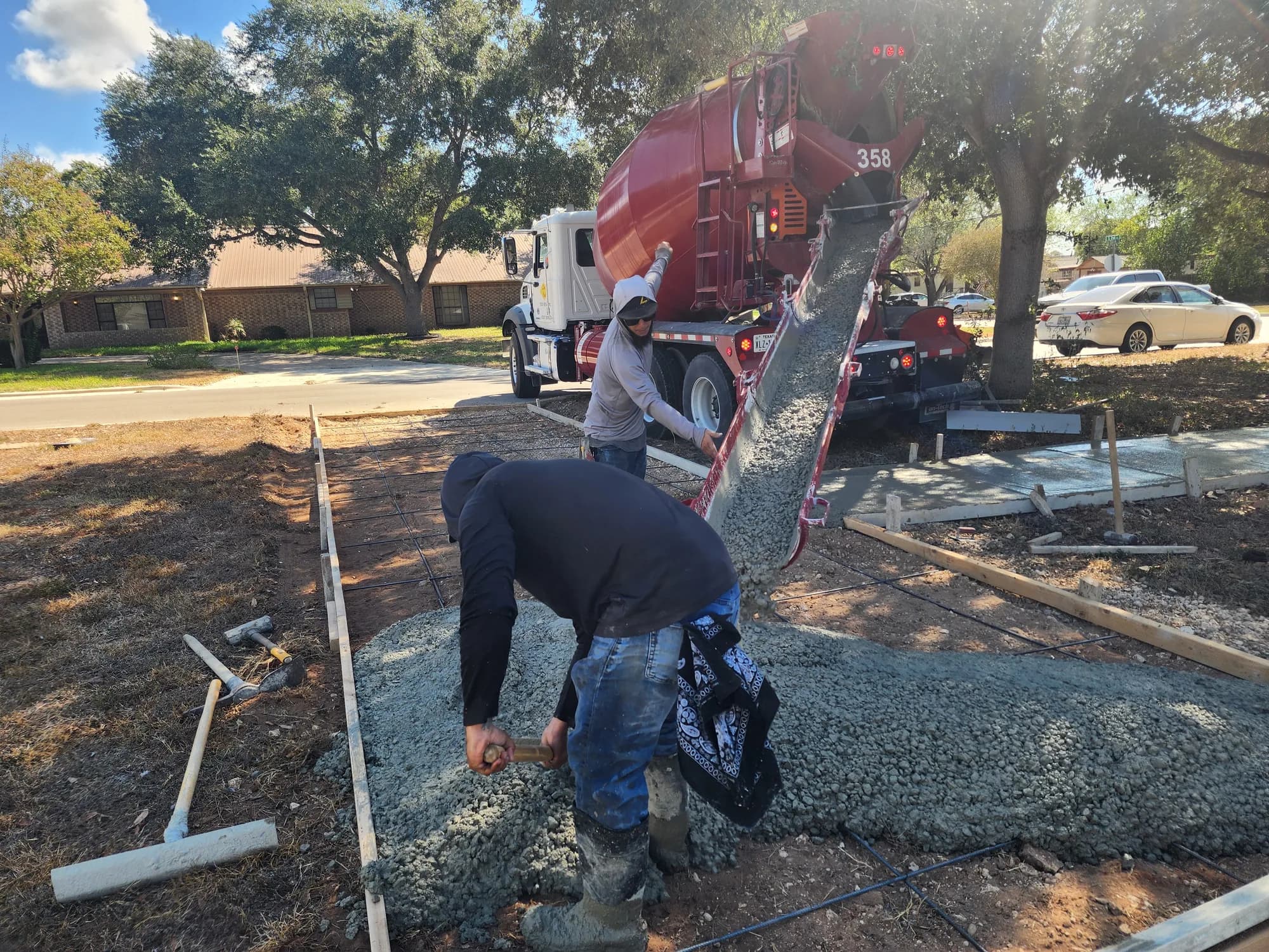 Sanders & Co crew pouring concrete inside prepared forms in San Antonio