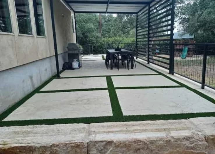 Covered patio with concrete pavers and grass joints near San Antonio