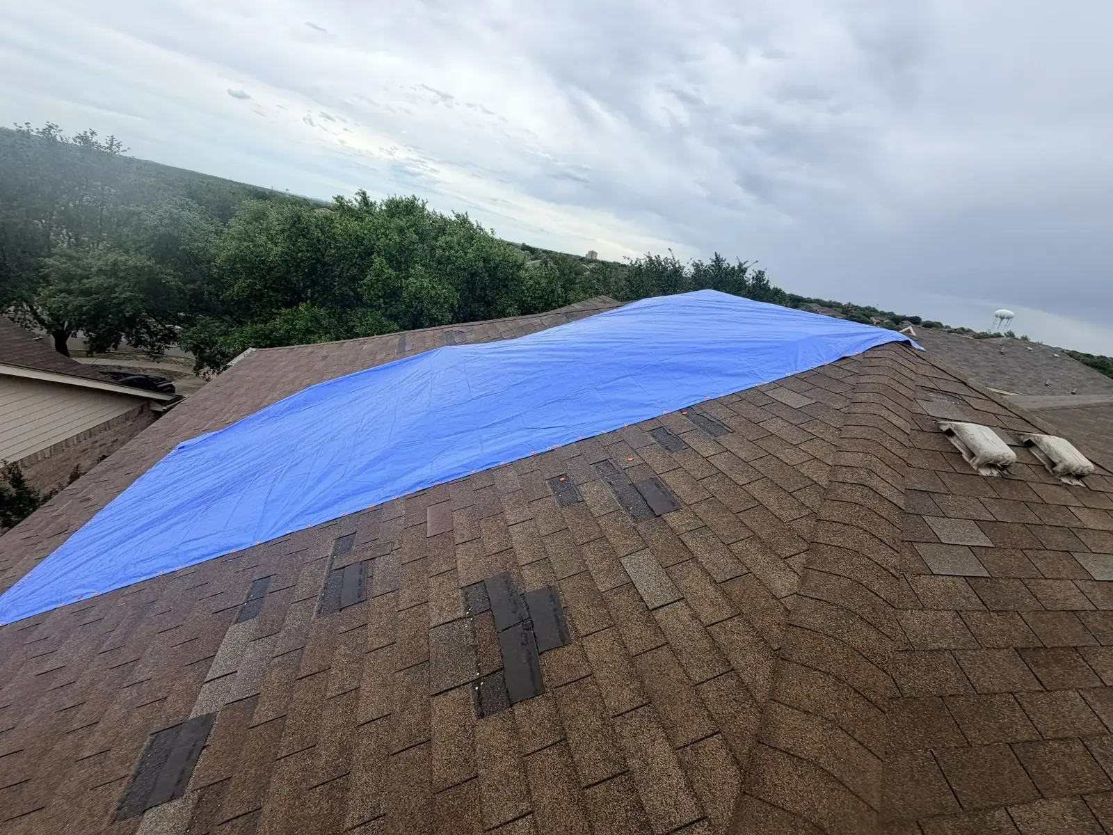 Emergency roof tarping after storm damage in San Antonio